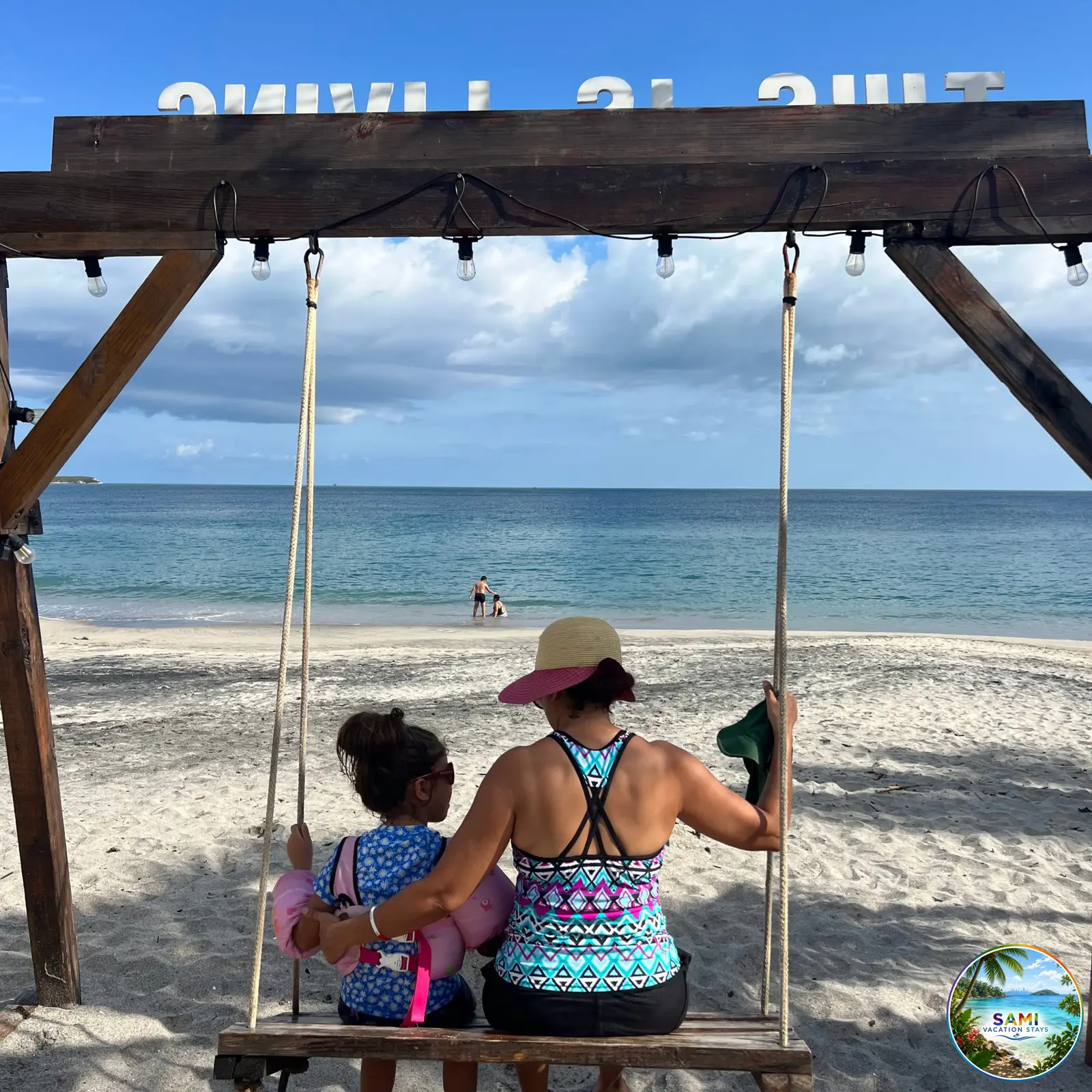 Mother and child on a beach swing