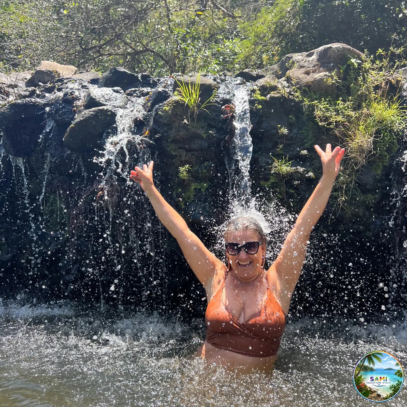 Woman enjoying a waterfall shower