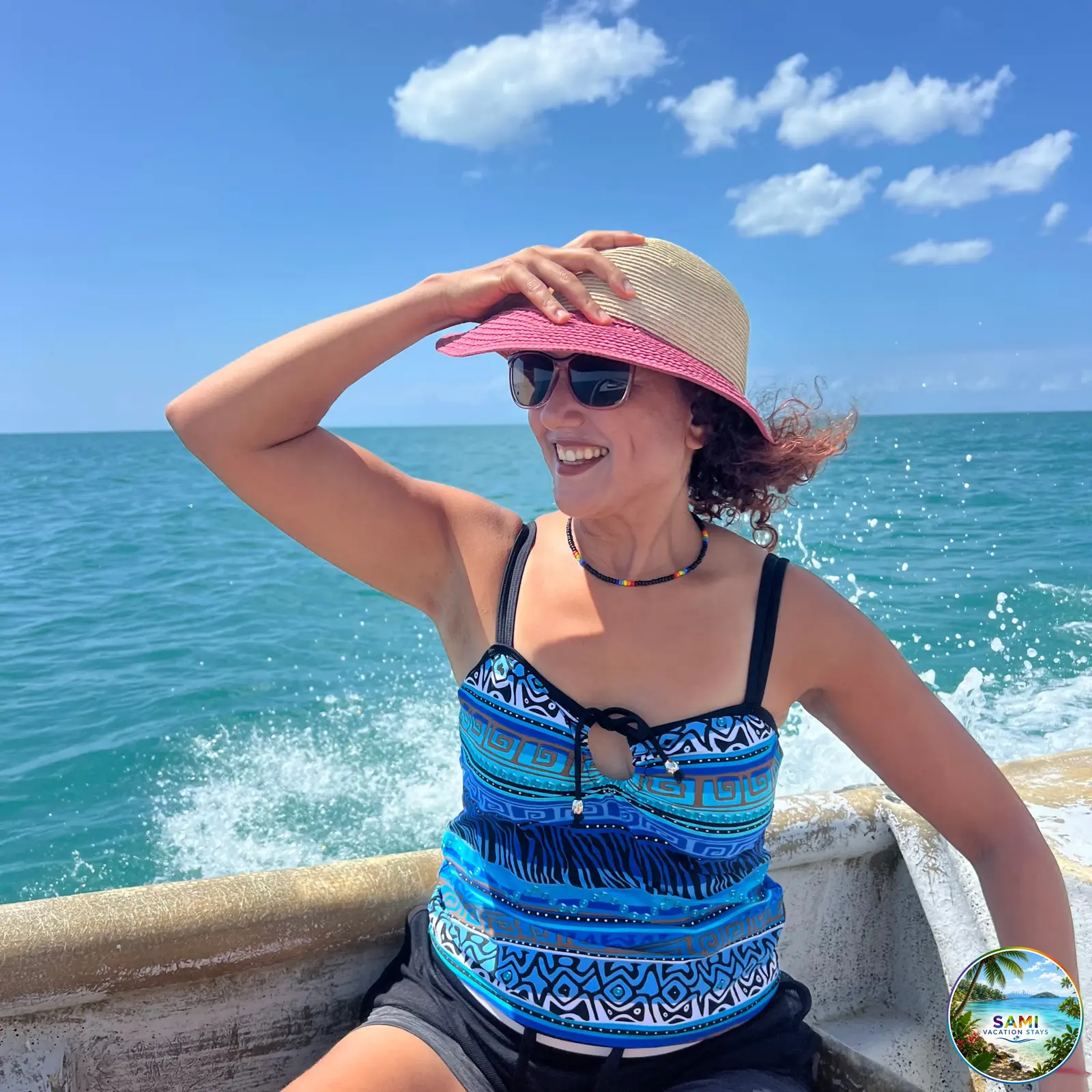 Woman in a sunhat on a boat ride on the ocean
