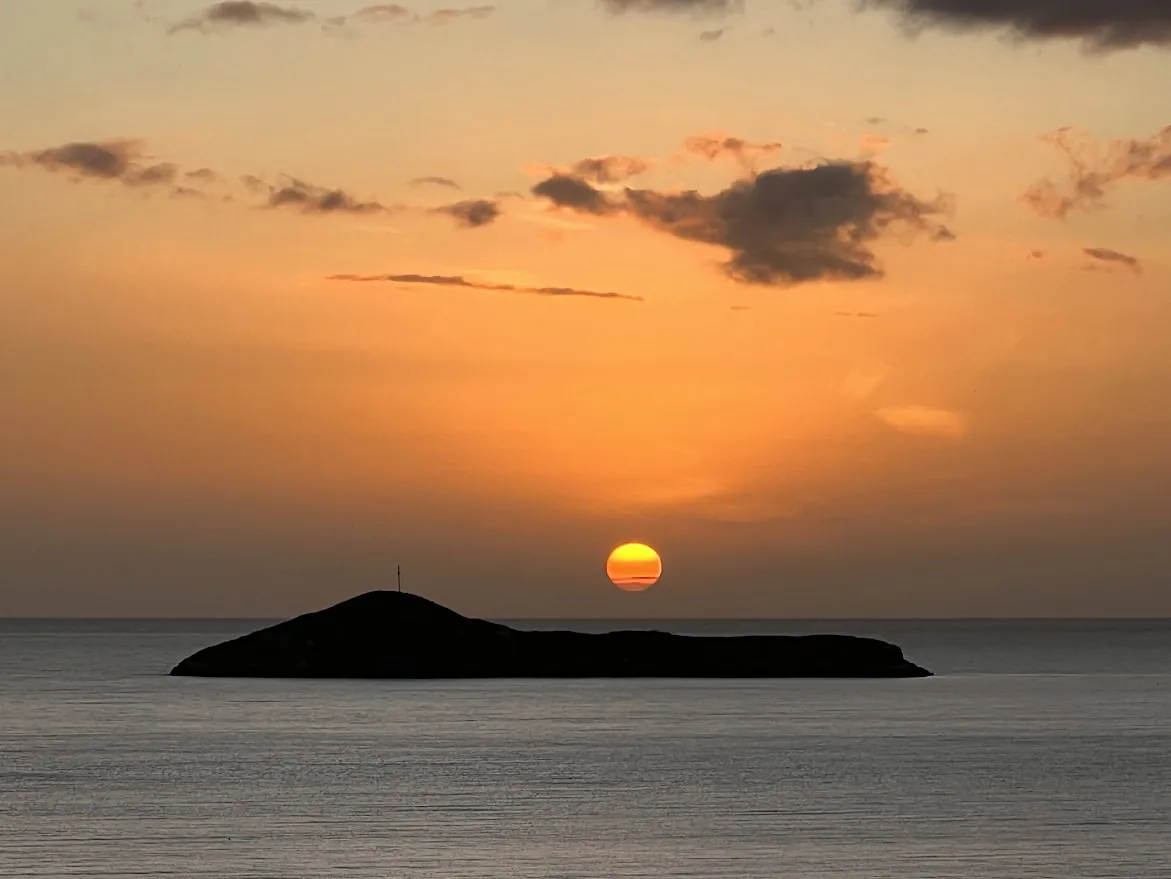 The sun setting behind a small island off the Panama coast